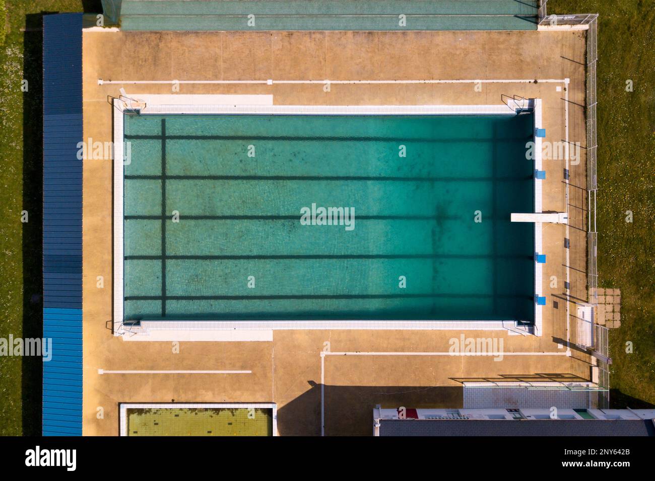 Aerial view of a municipal swimming pool not cleaned a month before