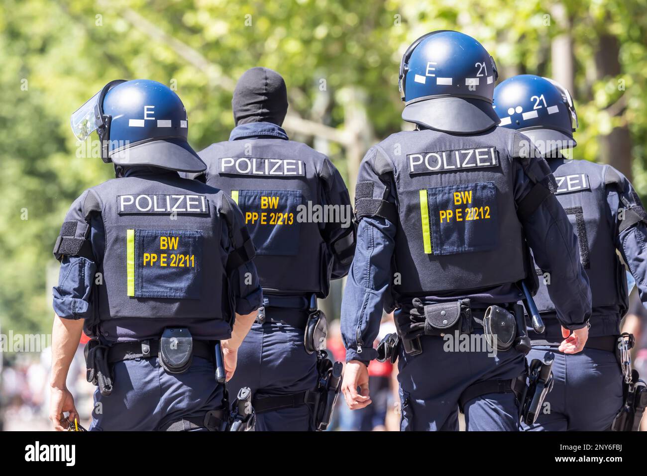 Police officers wearing helmets and protective equipment on their way