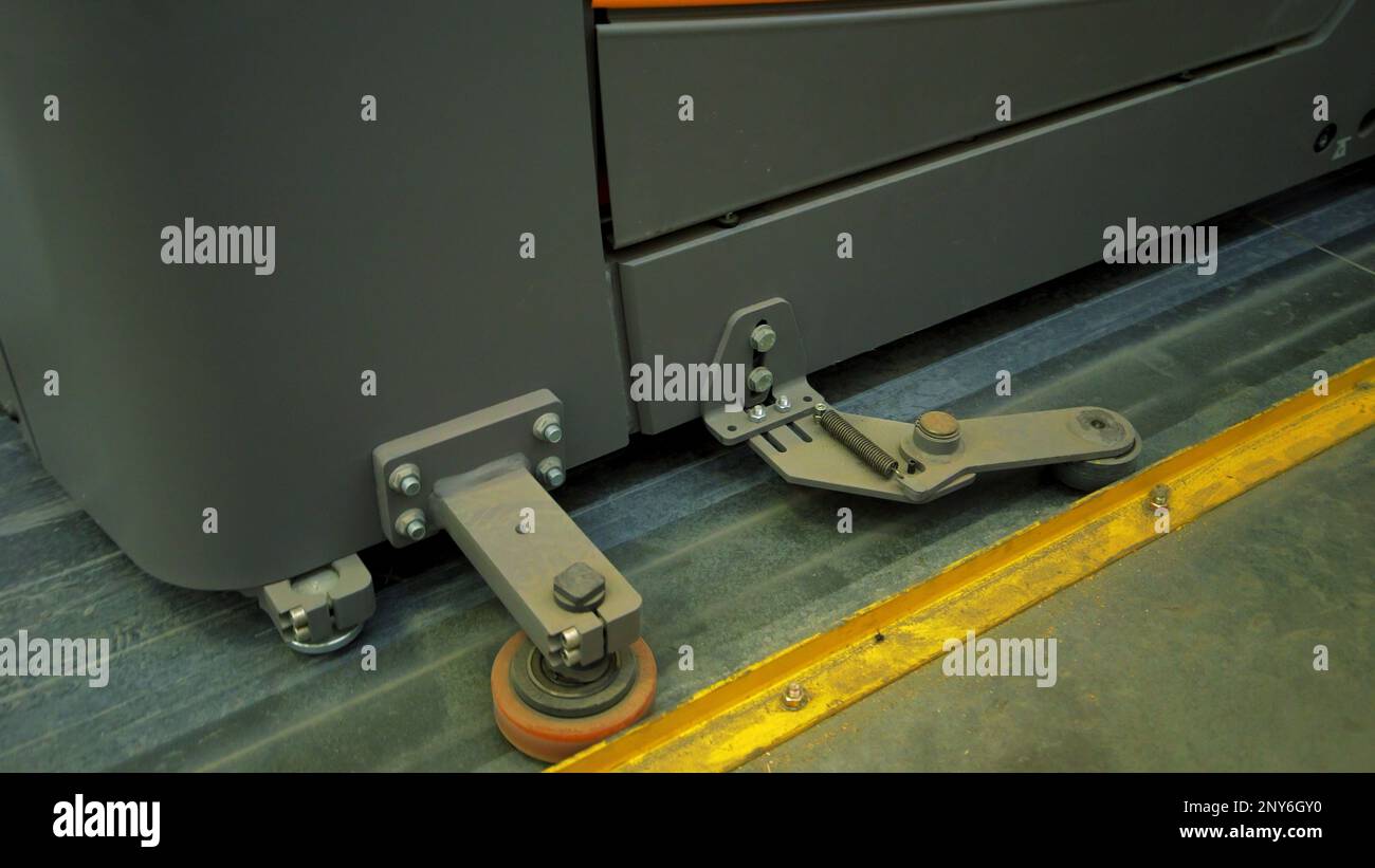 Hydraulic trolley for warehouse. Creative. Close-up of cart wheels for warehouse cargo. Manual hydraulic trolley in warehouse. Stock Photo
