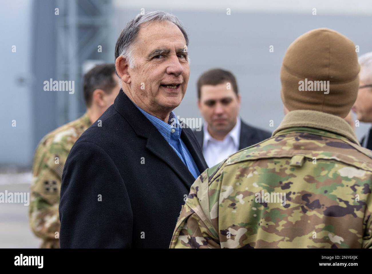 U.S. Senator John Boozman speaks to a Soldier assigned to the 2nd Battalion, 501st Aviation Regiment, Combat Aviation Brigade, 1st Armored Division (1 AD CAB), operationally controlled by the 1st Infantry Division (1 ID) during a tour of the 33rd airbase in Powidz, Poland, Jan. 19, 2023. The 1 AD CAB is among other units assigned to the 1 ID proudly working alongside NATO allies and regional security partners to provide combat-credible forces to V Corps, America's forward deployed corps in Europe. Stock Photo