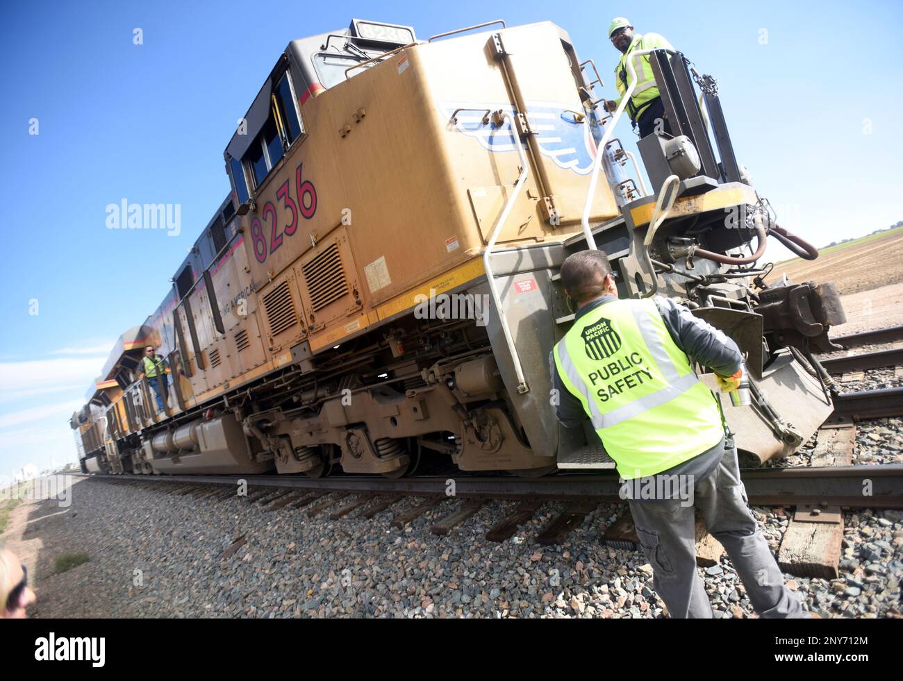 Carlos Hernandez stands just off to the side of the tracks as engineers