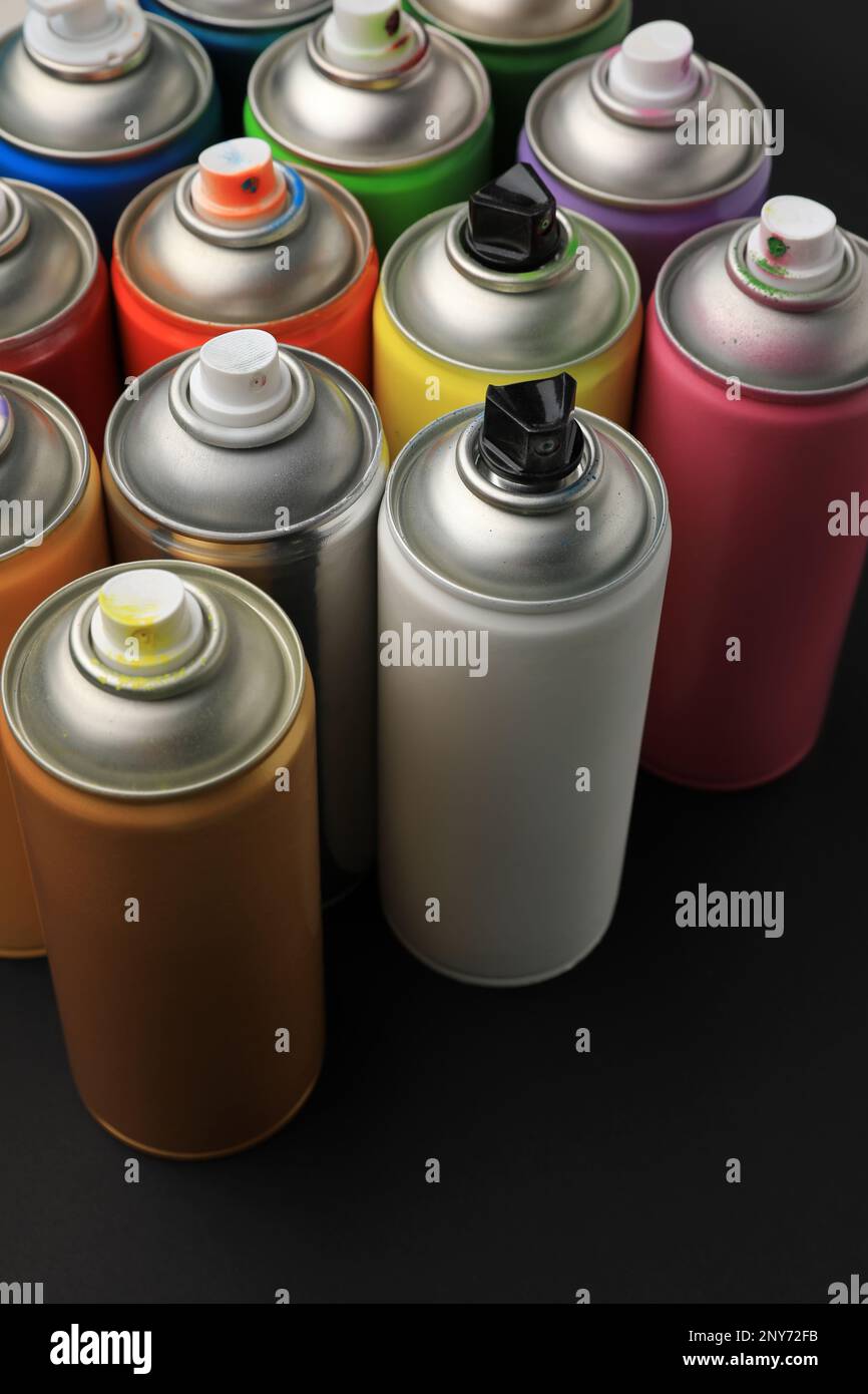 Cans of different graffiti spray paints on black background Stock Photo Alamy