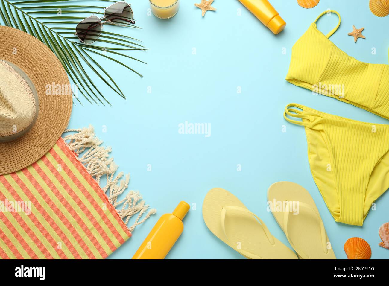 Frame made with different beach objects on light blue background, flat lay. Space for text Stock Photo