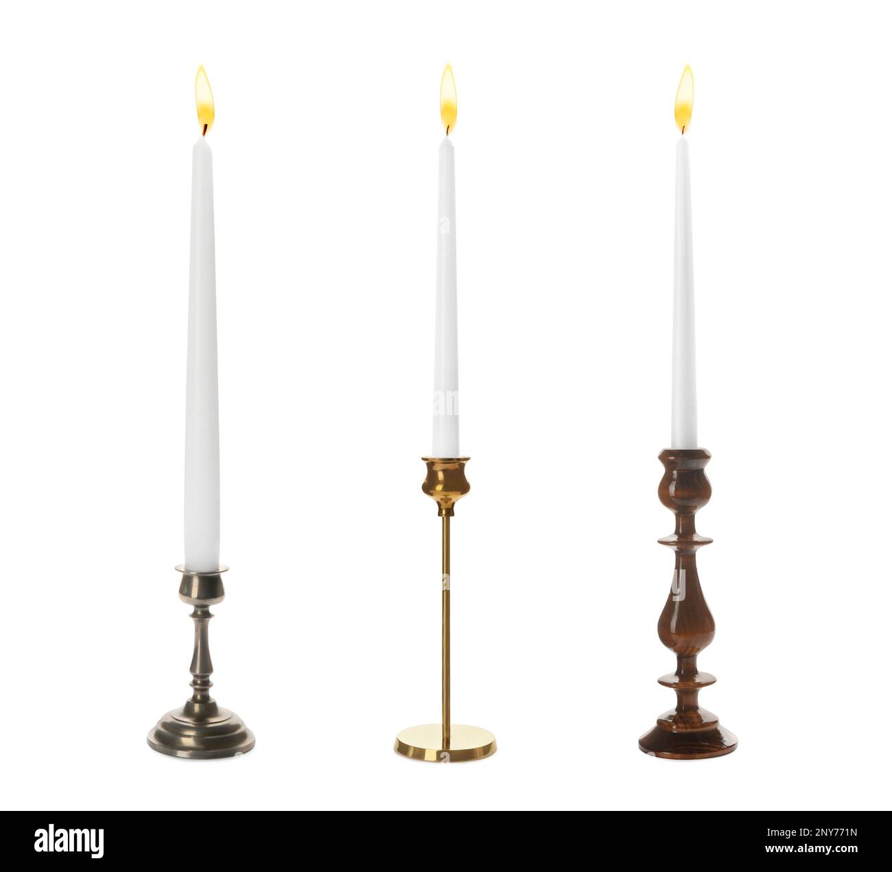 Set of different stylish candlesticks with burning candles on white