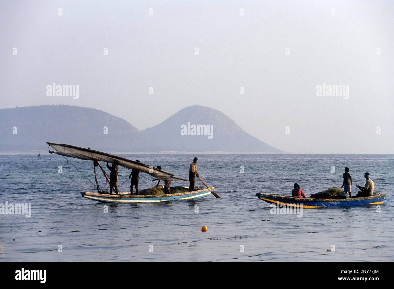 Fishermen rolling the Sailing boat cloth, Bay of Bengal in