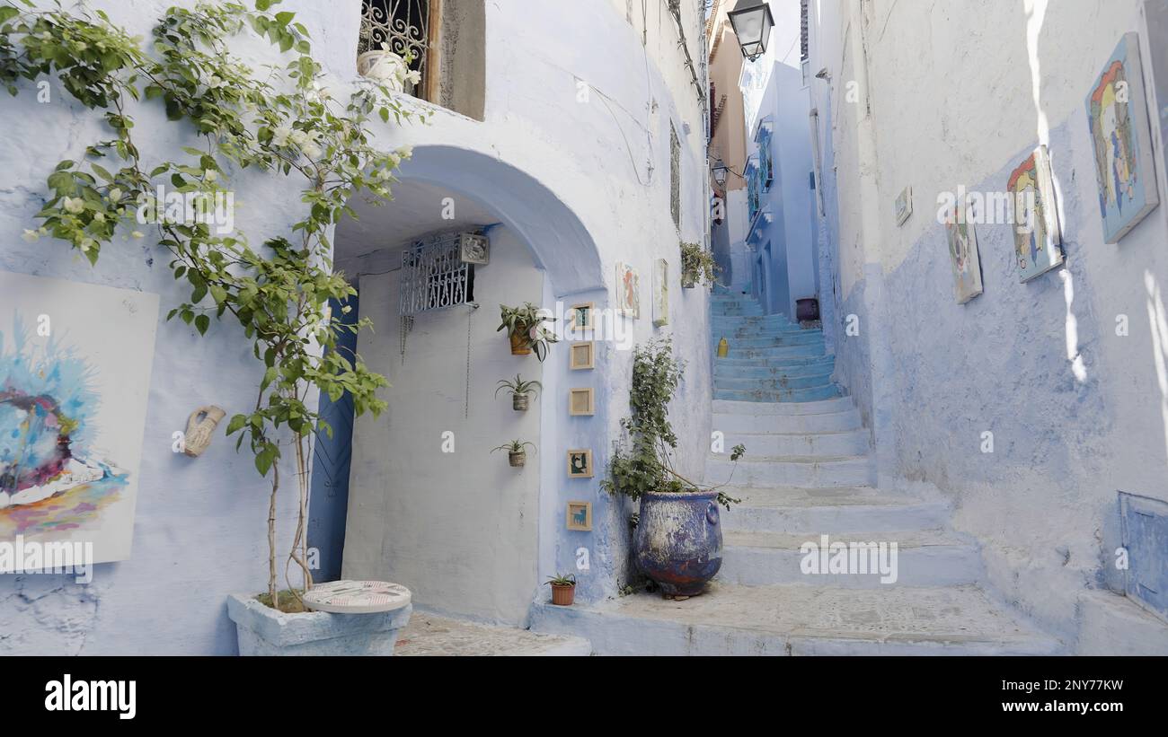Beautiful narrow streets of Greece. Action. Decorative elements, paintings and plants Stock Photo