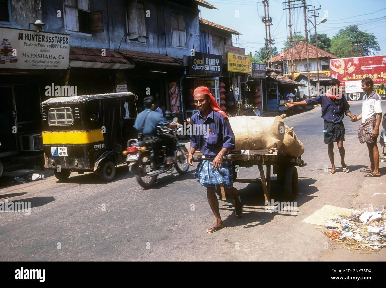 Coolie Pulling the hand cart at Kozhikode, Calicut, Kerala, India Stock