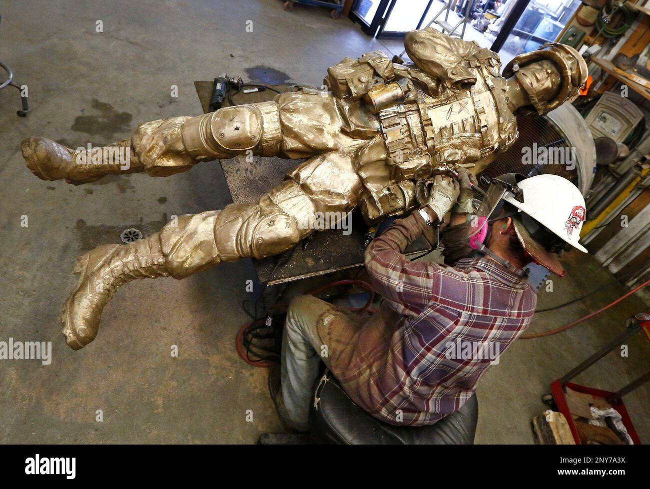 In a Sept. 21, 2017 photo, Dan Minosky works on one of the sculptures
