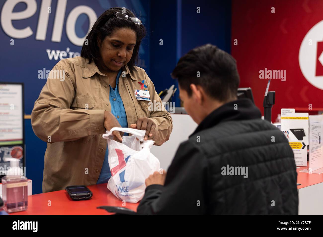 Tonja Norris, the manager of the Camp Foster Exchange, hands a customer