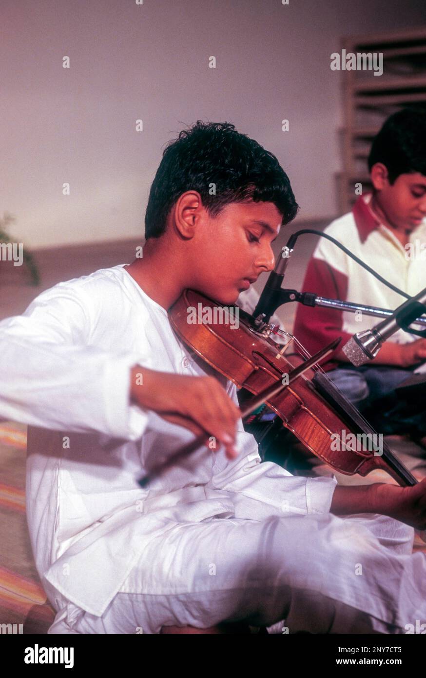 A boy Playing violin at Kerala, South India, India, Asia Stock Photo