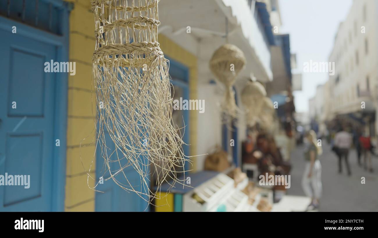 Beautiful narrow streets of Greece. Action. Decorative elements hanging and swaying in the wind Stock Photo