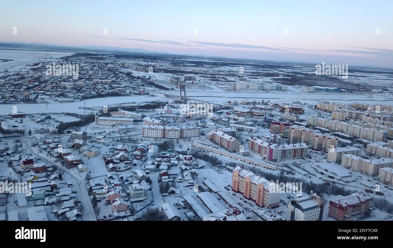 Aerial view of a big city with building roofs covered by snow. Clip ...