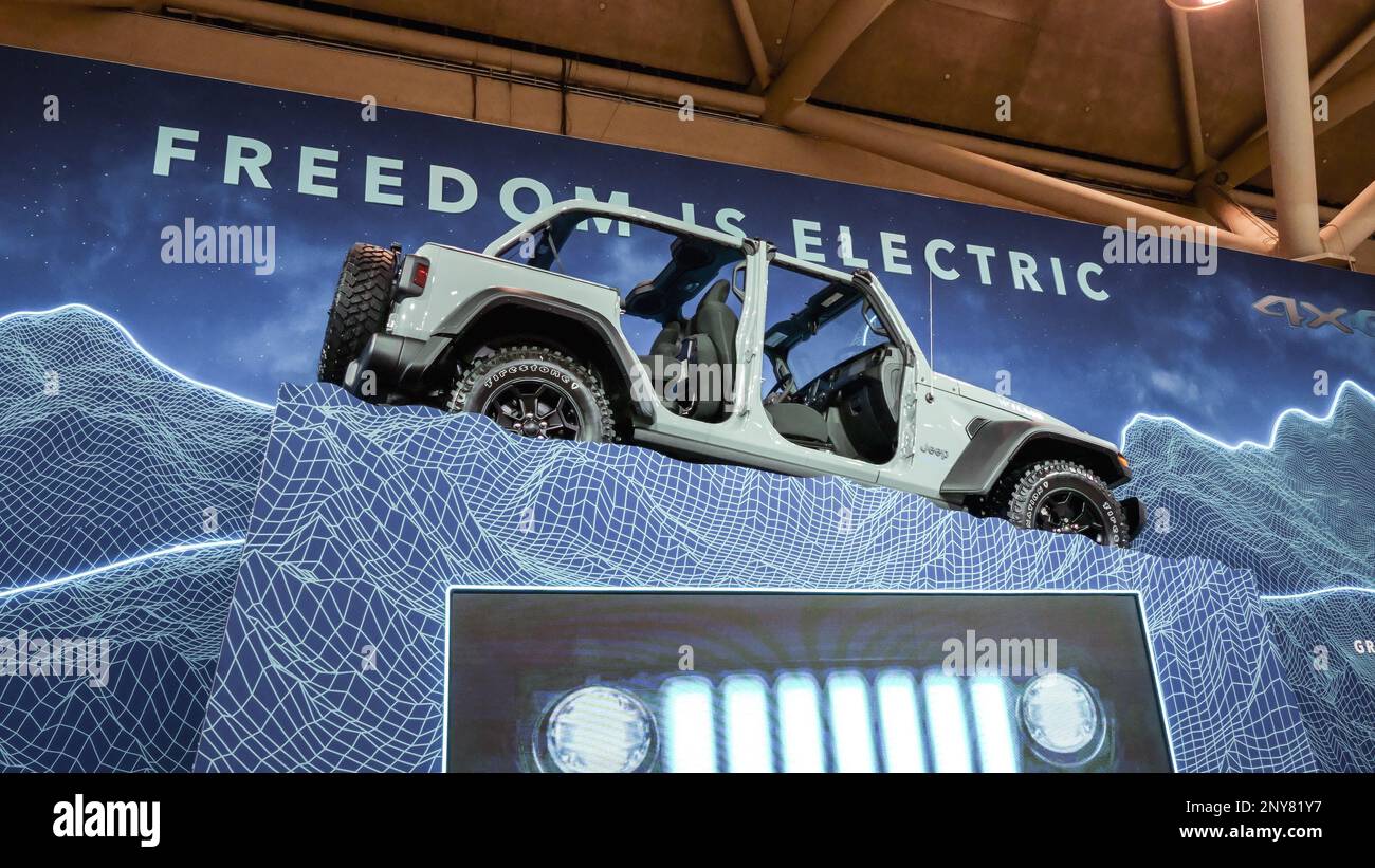 Grey Rubicon Jeep car on display. Crowds looking at new car models at Auto show. National