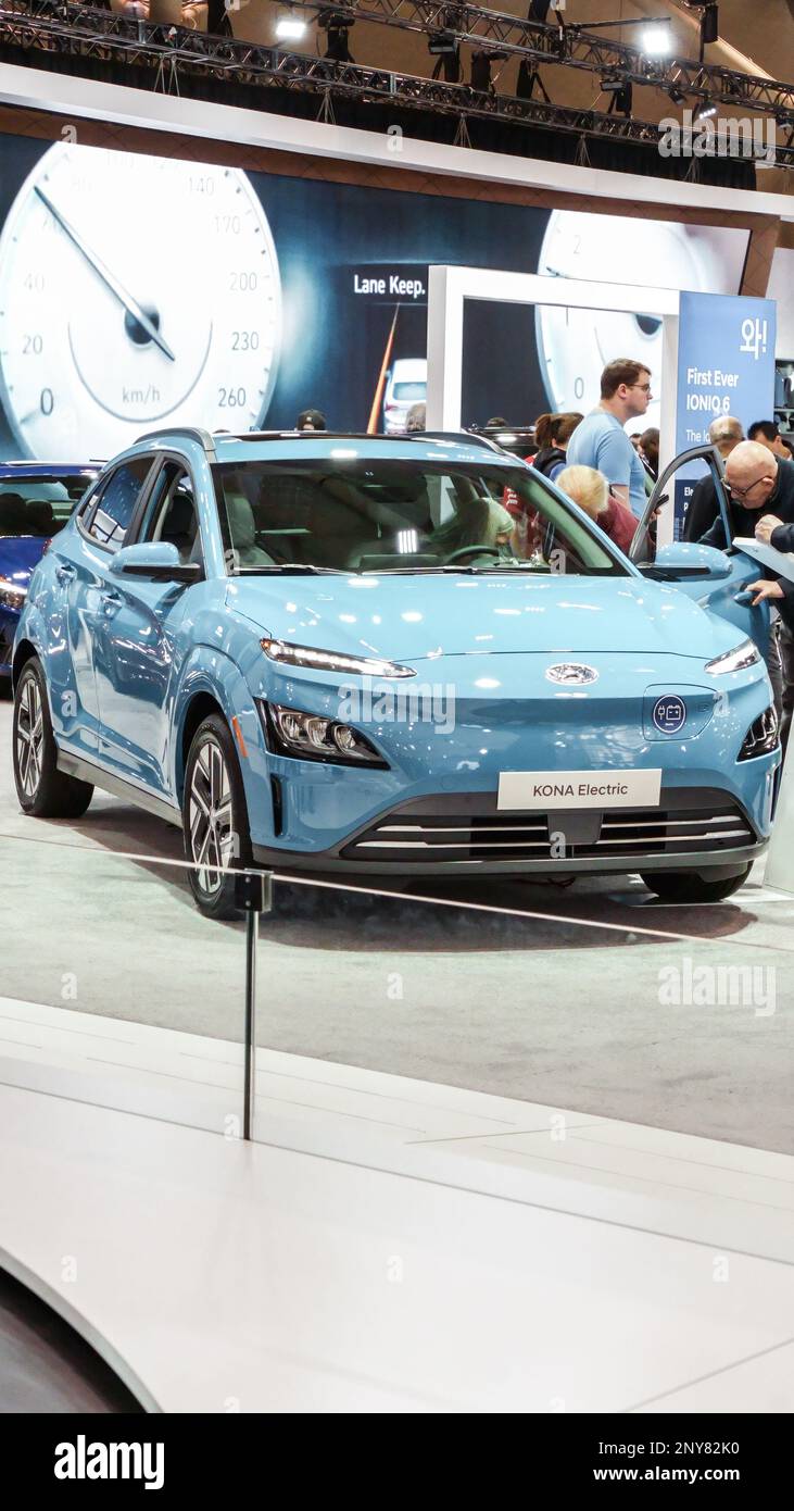 View of blue Hyundai Kona electric car on display. Vertical. Crowds looking at new car models at Auto show. National Canadian Auto Show with many car Stock Photo