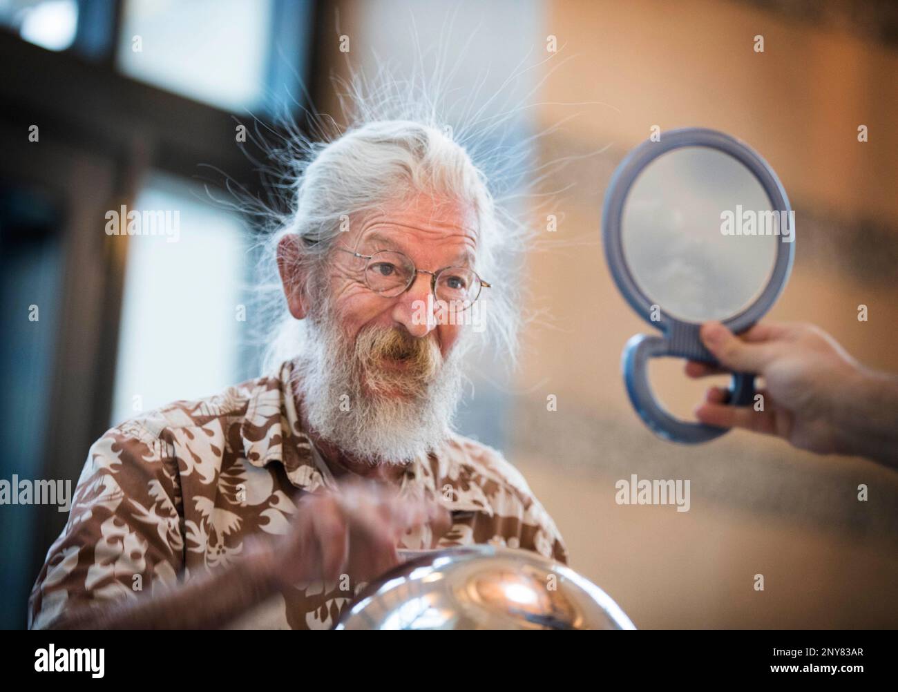 Herb Zimmerman of St. Paul checks out his reflection as his hair stands