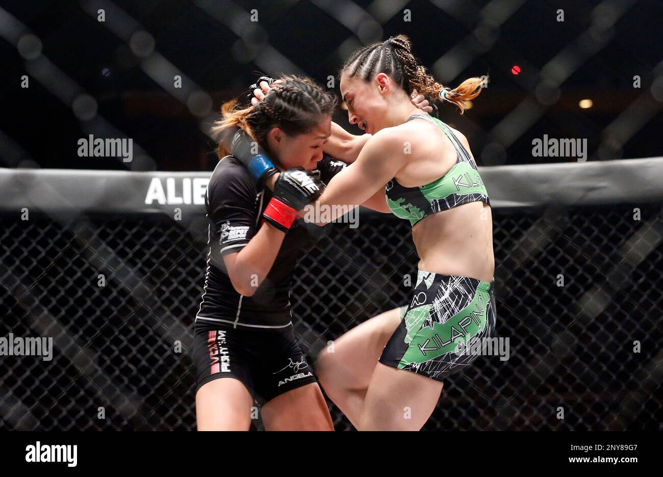 Singapore's mixed martial arts strawweight Angela Lee (in black) won