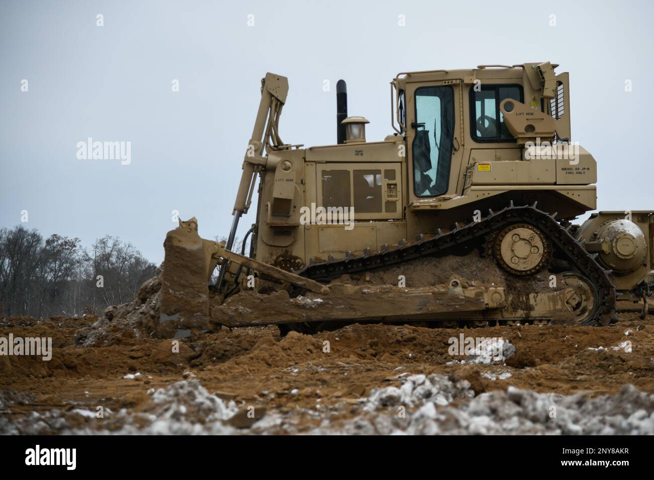 Soldiers from the 1432nd Engineer Company, Michigan National Guard use heavy equipment to move dirt during Northern Strike 23-1, Jan. 27, 2023, at Camp Grayling, Mich. Northern Strike’s winter iteration offers units a chance to train in a joint, all-domain, cold-weather environment. Stock Photo
