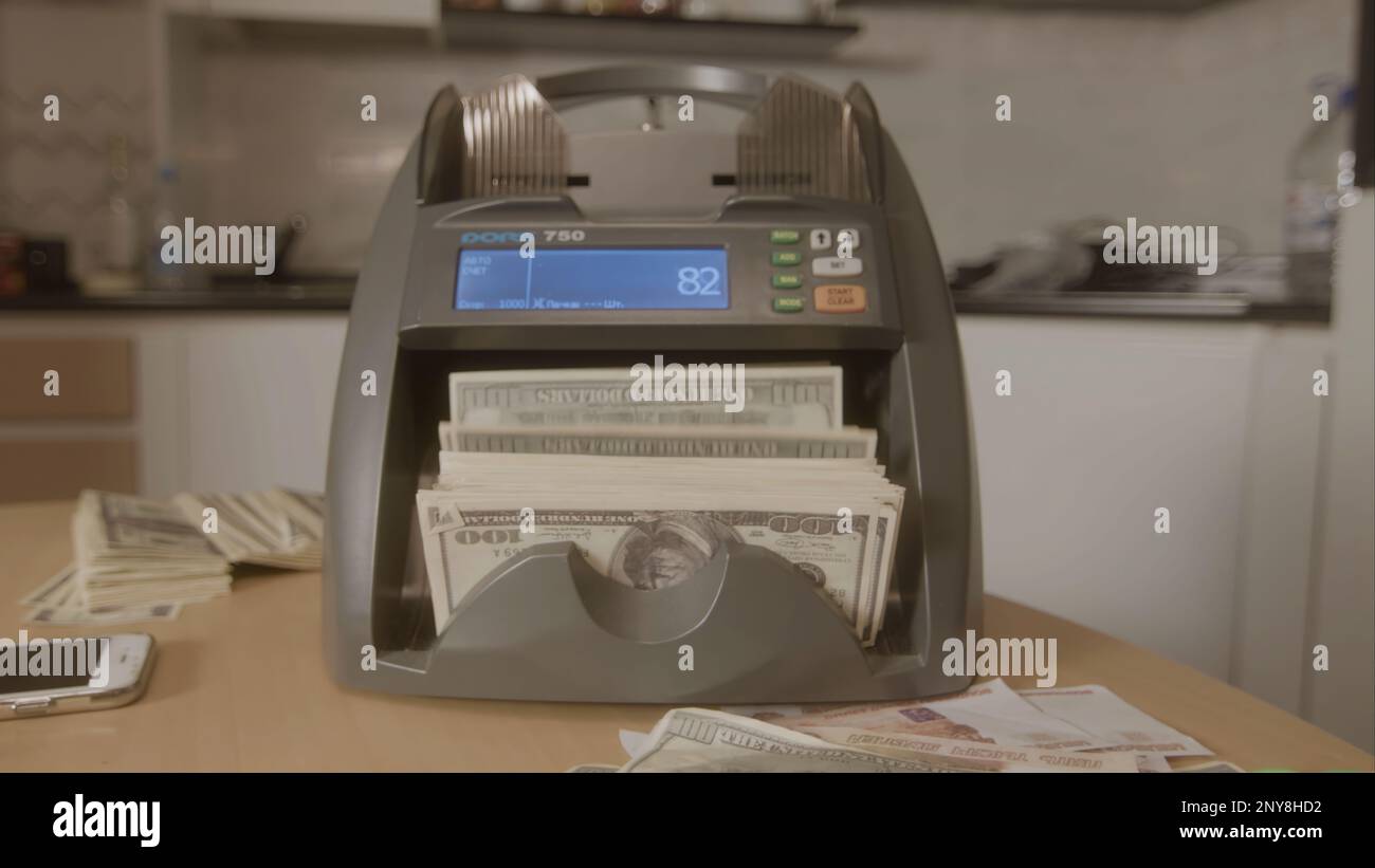 Electronic money counter machine is counting the dollar banknotes