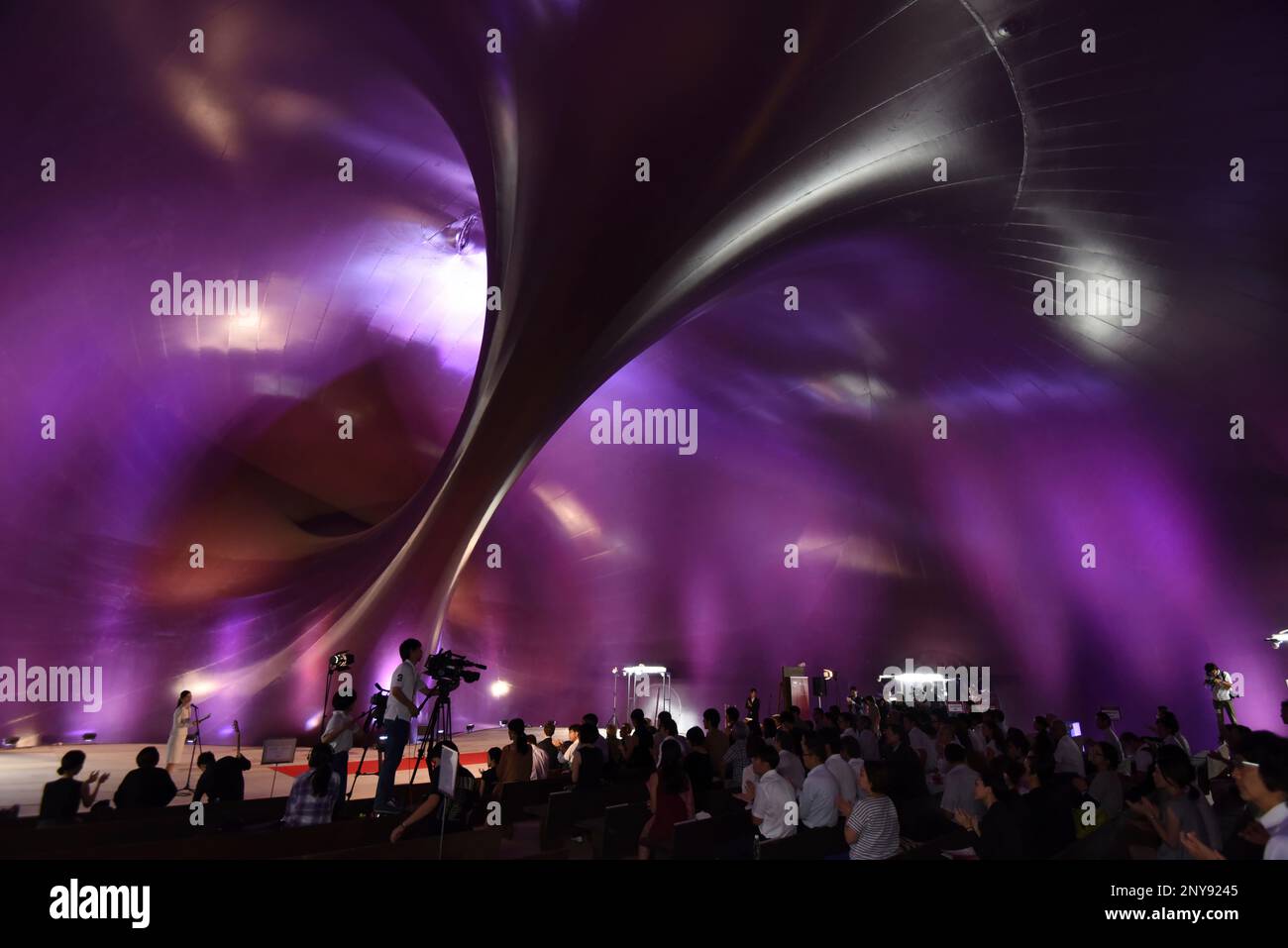 People attend an opening ceremony of "The Lucerne Festival Ark Nova 2017 in Tokyo Midtown" to mark Mid Town's 10th anniversary at Tokyo Midtown in Minato Ward, Tokyo on Sep.19, 2017. The venue called Ark Nova is 18 meters high, 30 meters across and 36 meters deep portable concert hall. It was designed by the Japanese architect Arata Isozaki and the British sculptor Anish Kapoor to support recovery from the East Japan Earthquake. ( The Yomiuri Shimbun via AP Images ) Stock Photo