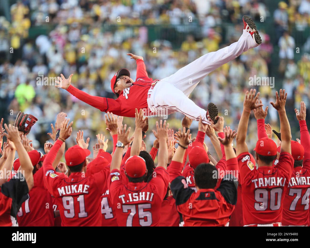 Hiroshima Toyo Carp manager Koichi Ogata is thrown in the air several