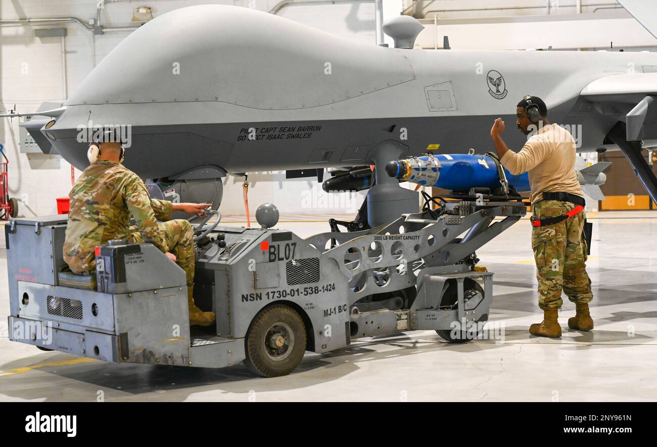 Airmen from the 29th Aircraft Maintenance Unit load inert munition on ...