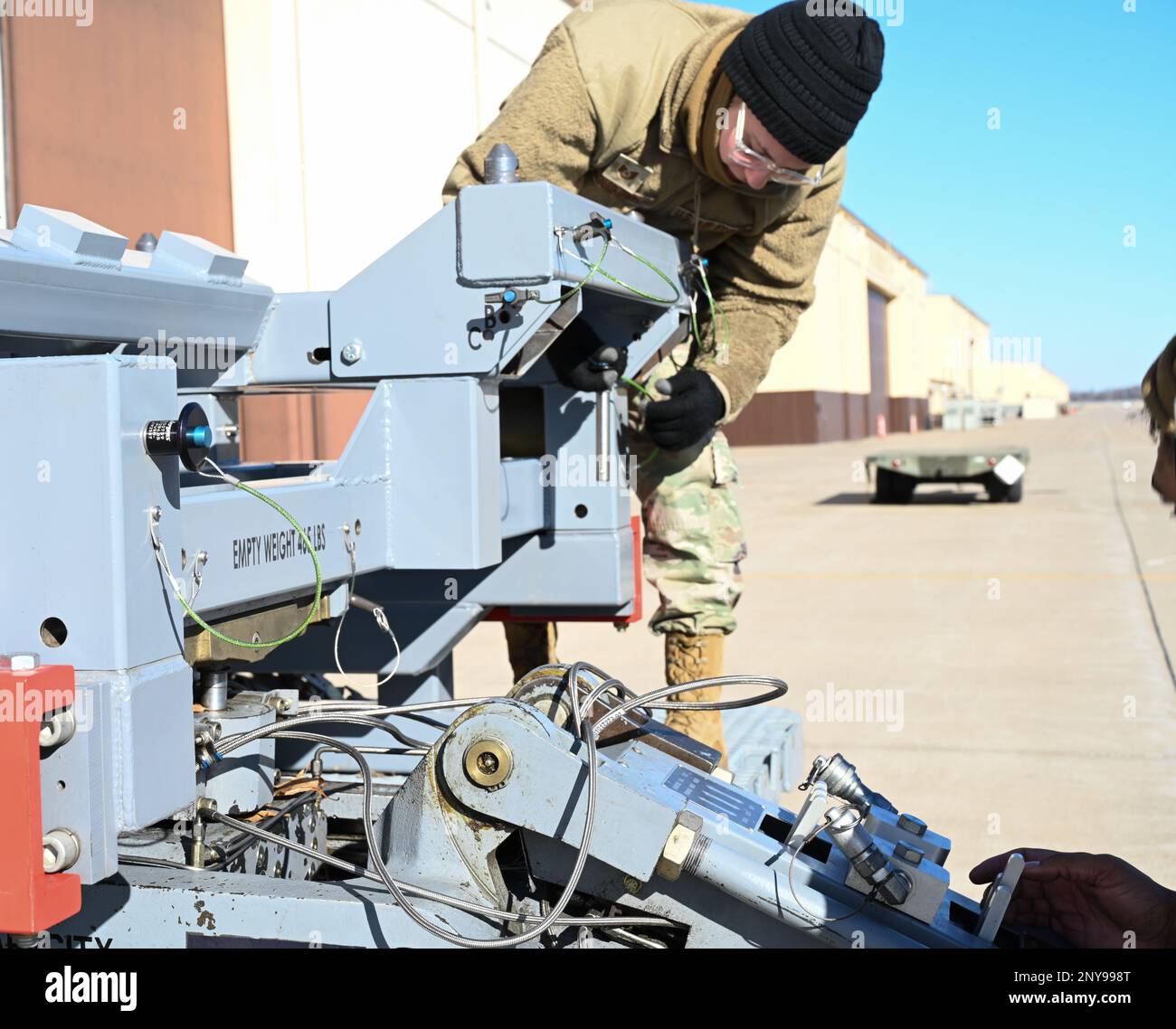 Technical Sgt. Kylie Boucher, 509th Aircraft Maintenance Squadron,weapon expeditor, helps attach the jammer to the launcher loading system (LLS) adapter at Whiteman Air Force Base, Missouri, Feb. 2, 2023. Using the LLS streamlines the reconfiguration capabilities by reducing the man hours and equipment used to load. Stock Photo