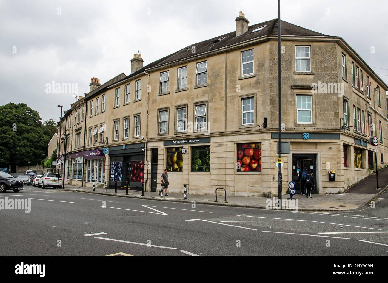 Bath, UK - September 3, 2022:  View of shops at Bear Flat in Bath including a branch of the Co-Op supermarket on a cloudy summer day in Somerset. Stock Photo