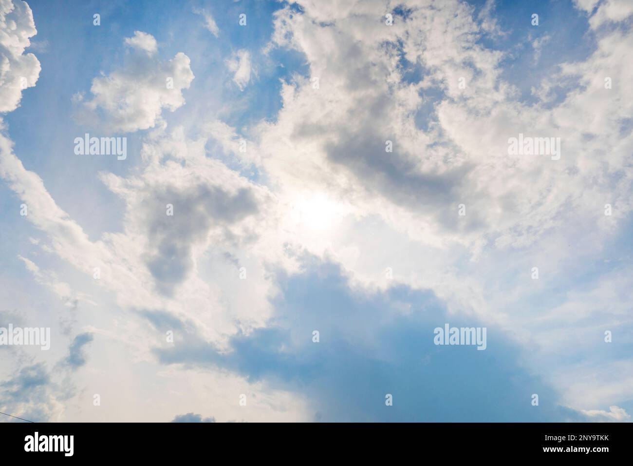 Blue sky with clouds and sun. Beautiful background. Stock Photo