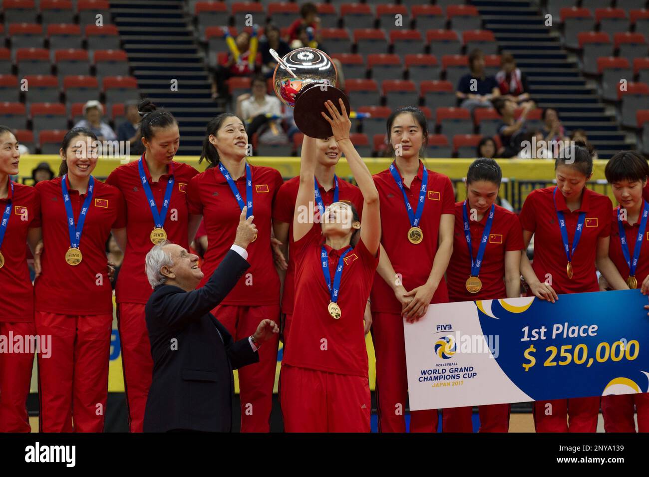 Winner the Chinese women's national volleyball team members pose with their trophy on the podium