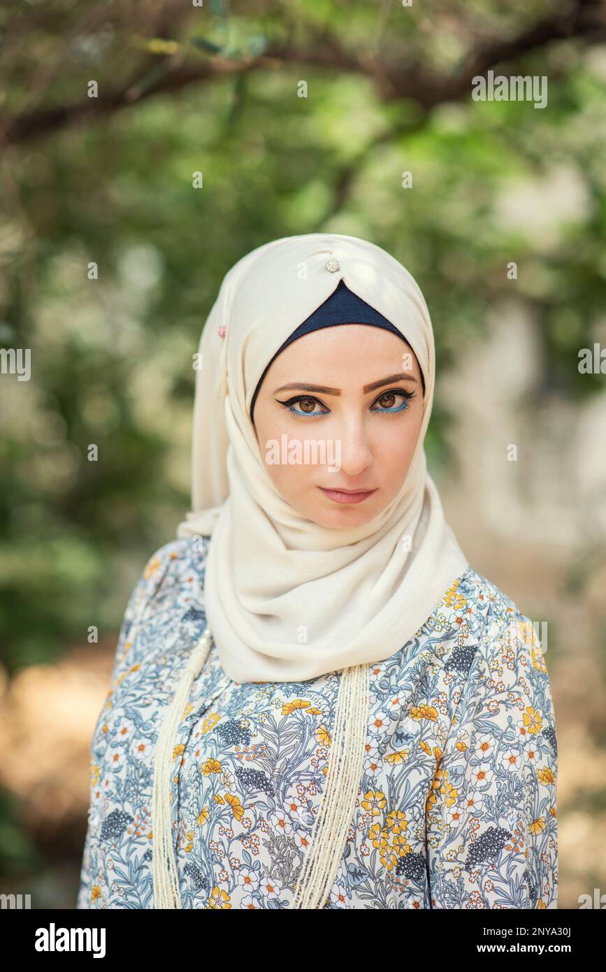 Beautiful Muslim woman staring outdoors Stock Photo