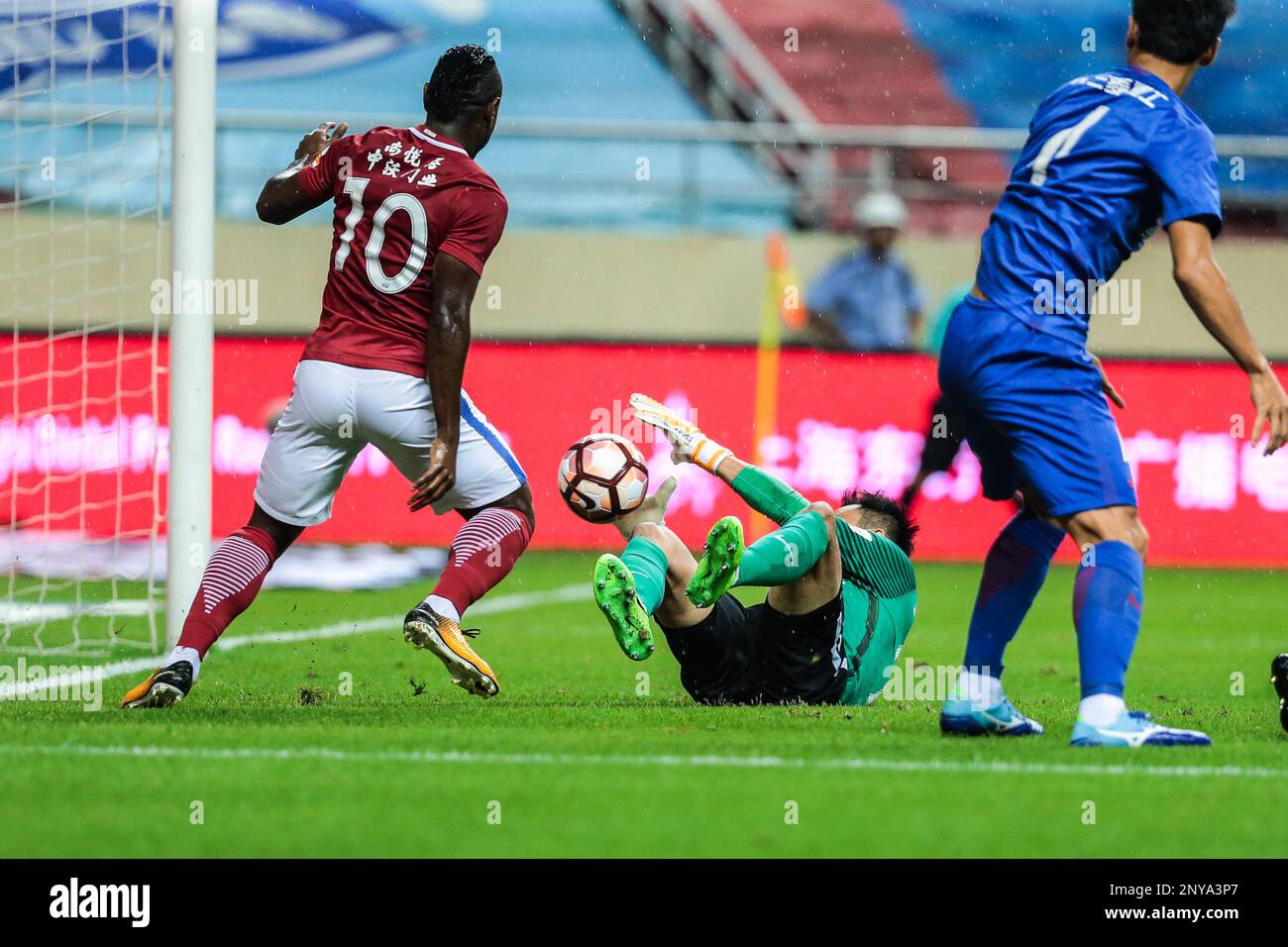 Cameroonian football player Christian Bassogog, left, of Henan Jianye, shoots against Shanghai Greenland Shenhua in their 24th round match during the 2017 Chinese Football Association Super League (CSL) in Shanghai, China, 10 September 2017.(Imaginechina via AP Images) Stock Photo