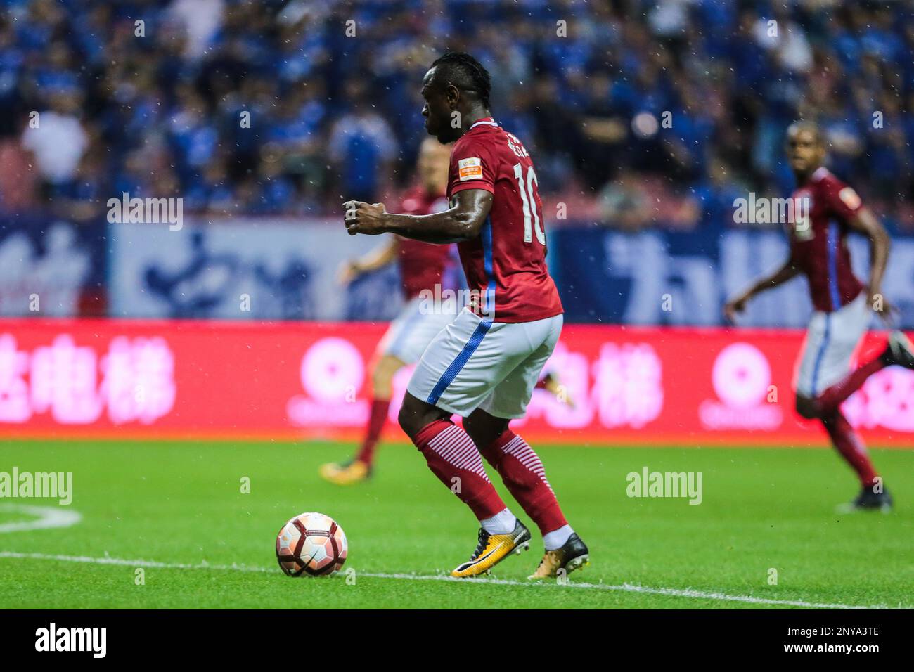 Cameroonian football player Christian Bassogog of Henan Jianye dribbles the ball against Shanghai Greenland Shenhua in their 24th round match during the 2017 Chinese Football Association Super League (CSL) in Shanghai, China, 10 September 2017.(Imaginechina via AP Images) Stock Photo
