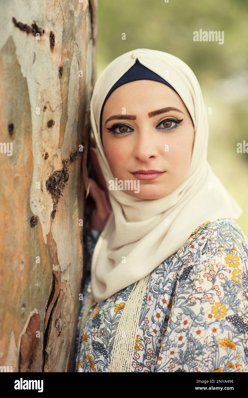 Beautiful Muslim woman looking at camera outdoors Stock Photo