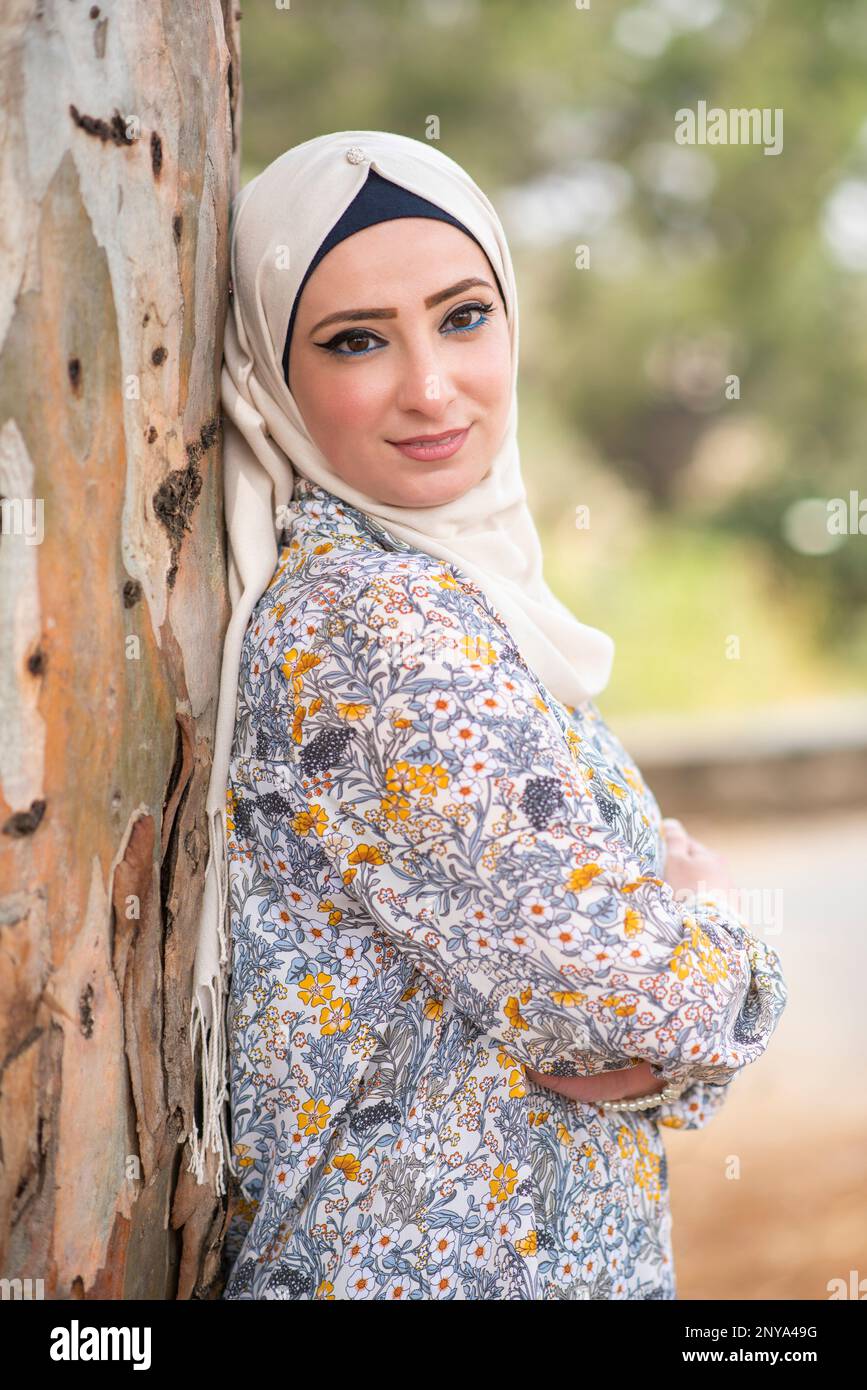 Happy muslim woman looking away smiling ouutdoors Stock Photo