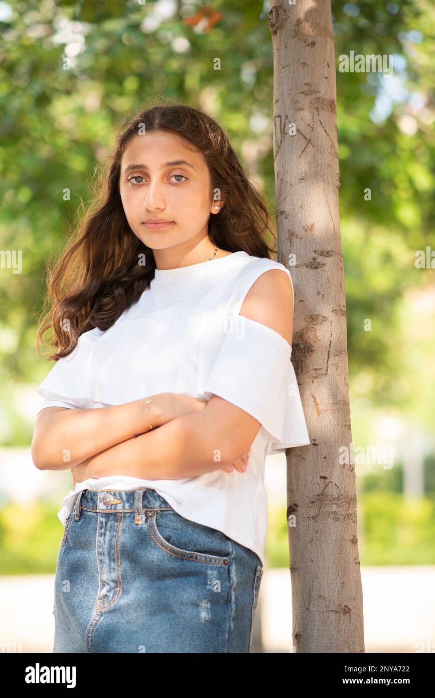Beautiful teenage girl looking at camera outdoors Stock Photo