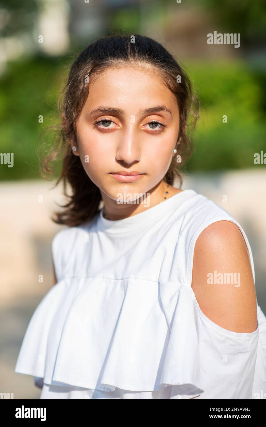 Serious teenage girl looking at camera otudoors Stock Photo