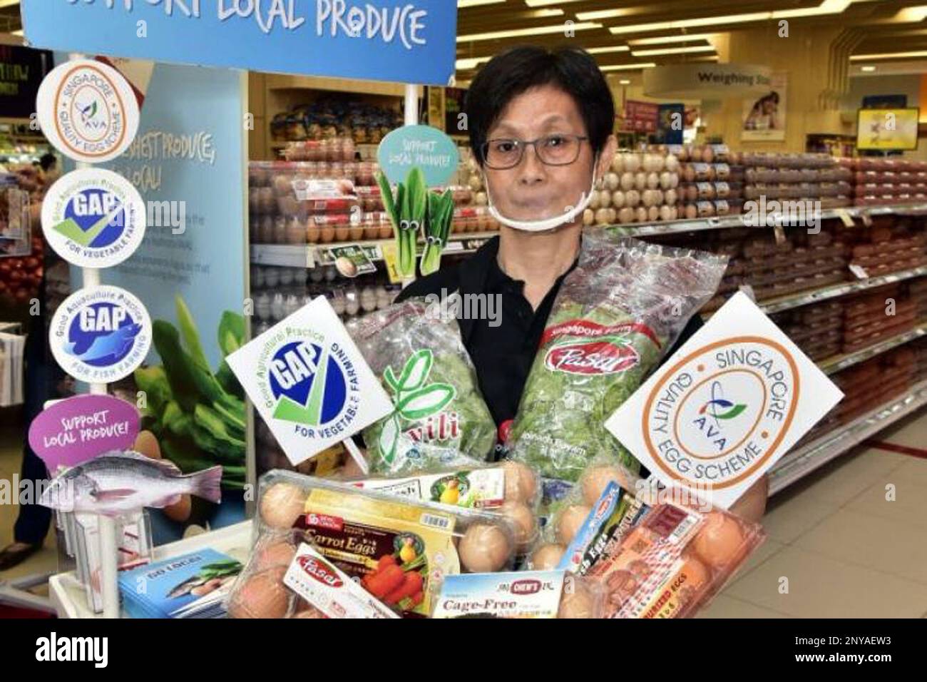 A sales promoter holding up some of the 17 Made in Singapore varieties  available at FairPrice. FairPrice commits another $1 million to support of  local producers through Suppliers Support and Devt Programme(SSDP). (