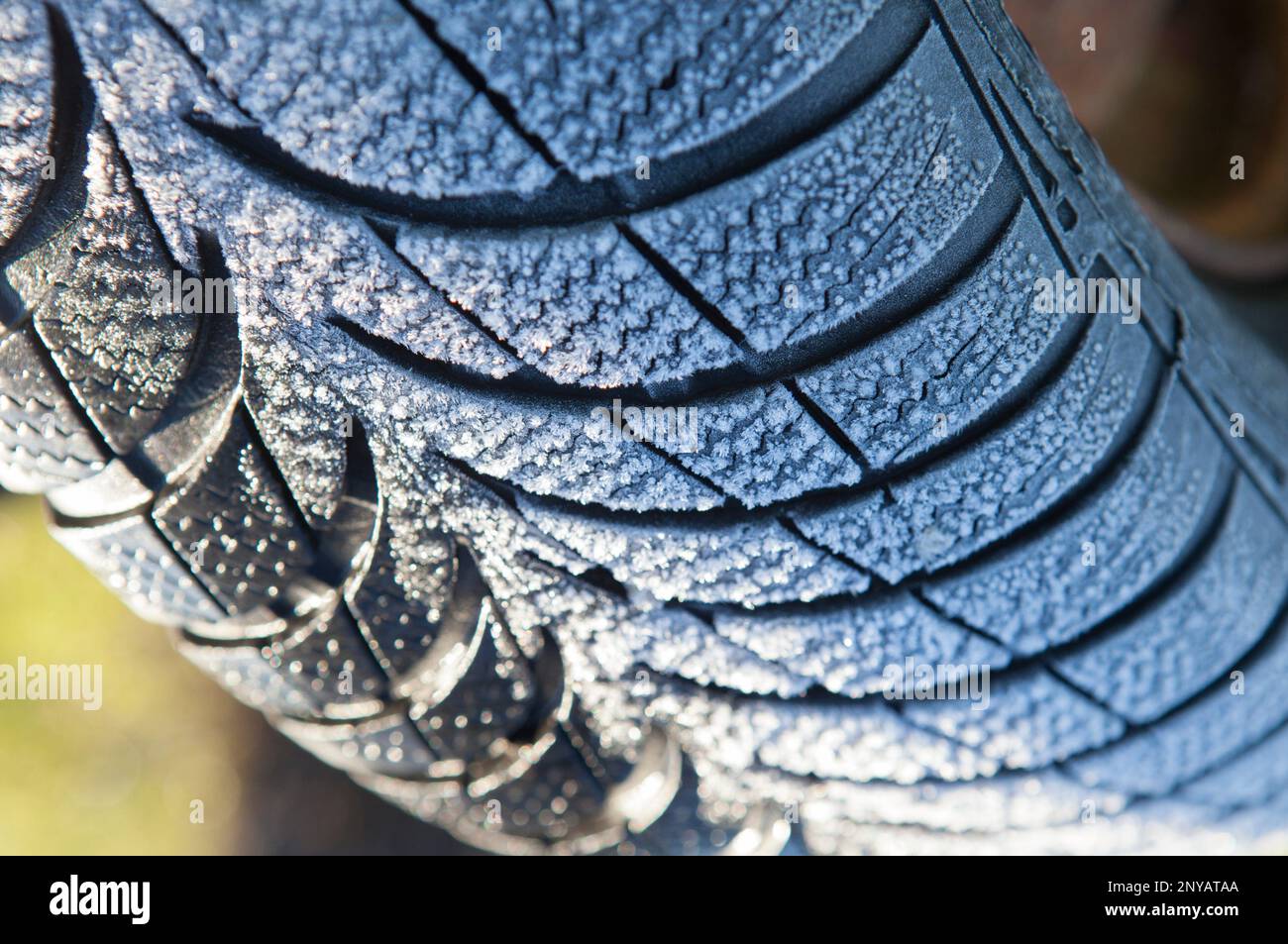 Frost covered tire surface. Safe driving on winter concept. Stock Photo