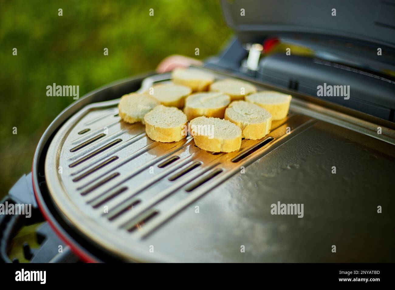 Prepare breakfast with bread, roasting bruschetta on the barbecue gas