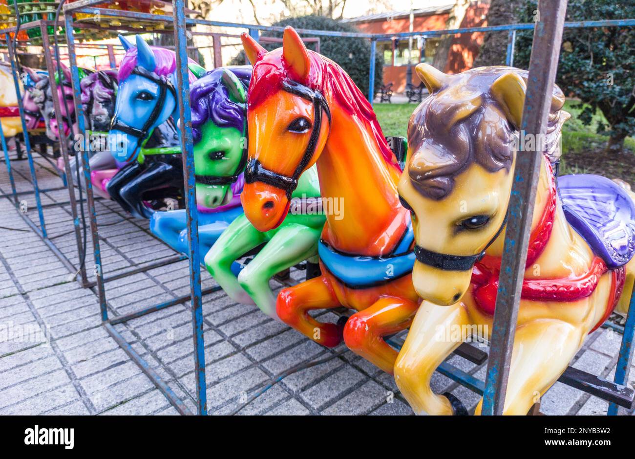 Horses out of merry-go-round placed on line. Outdoors shoot. Stock Photo