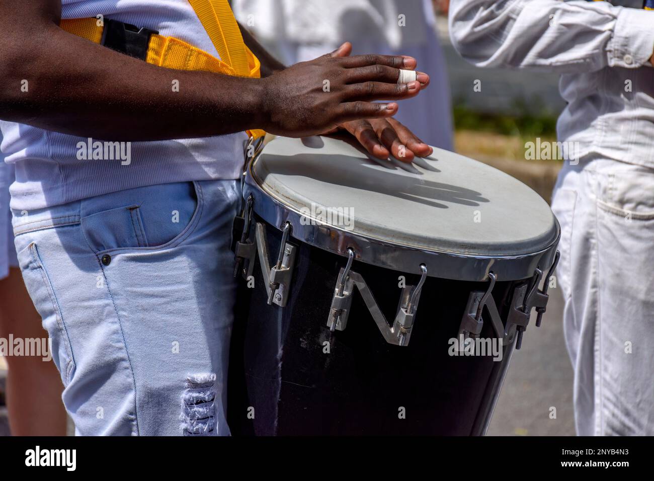 Atabaque drum player in the streets of Brazil during brazilian samba presentation. Stock Photo