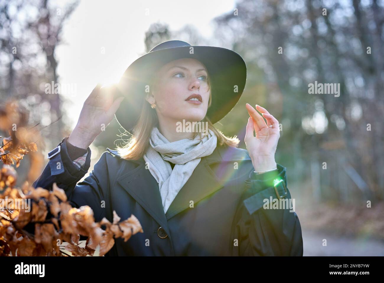 Young woman in forest with a hat and sunshine Stock Photo