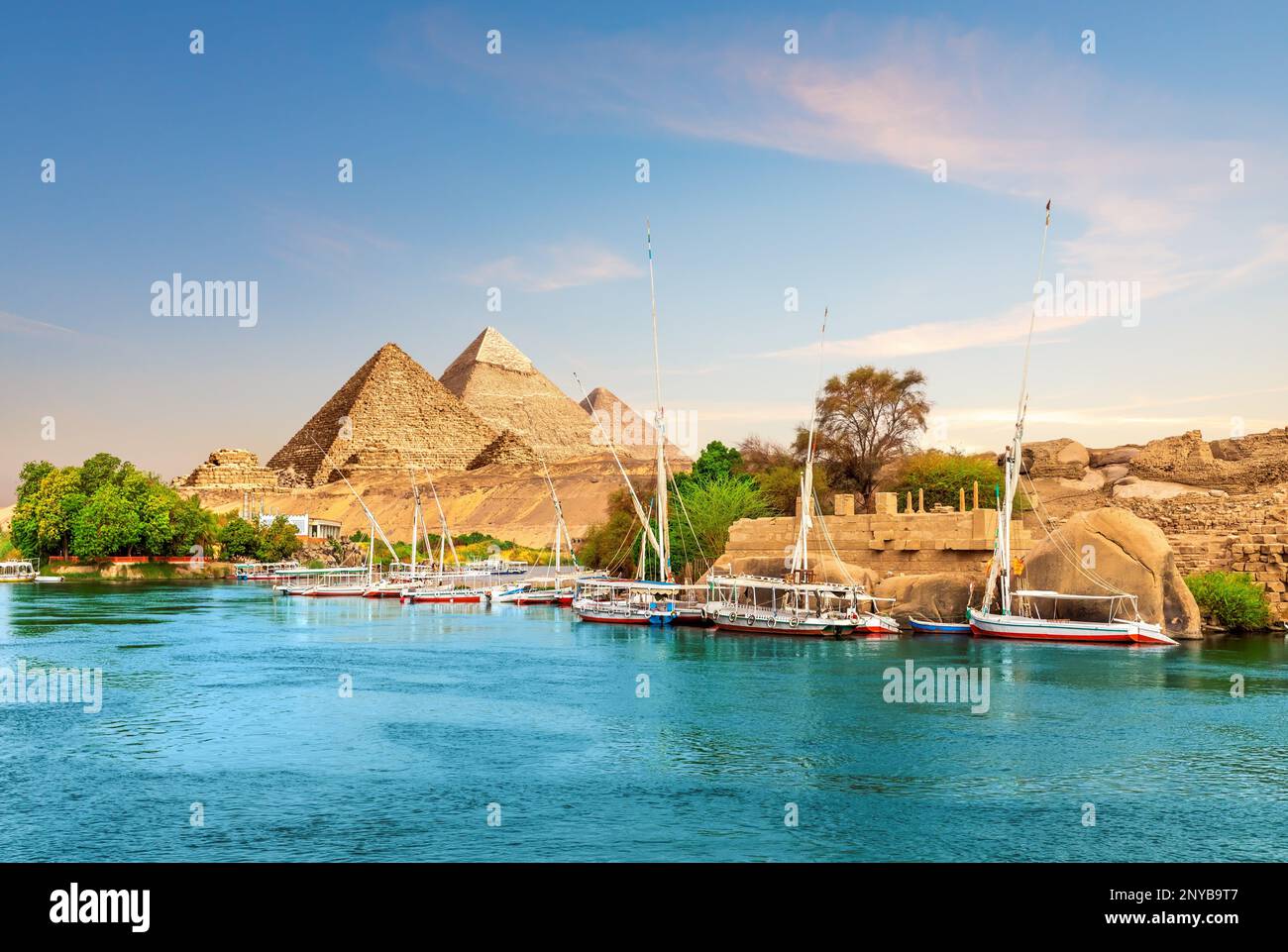 Ancient rocks and sailboats on the bank of the Nile, Aswan, Egypt. Stock Photo