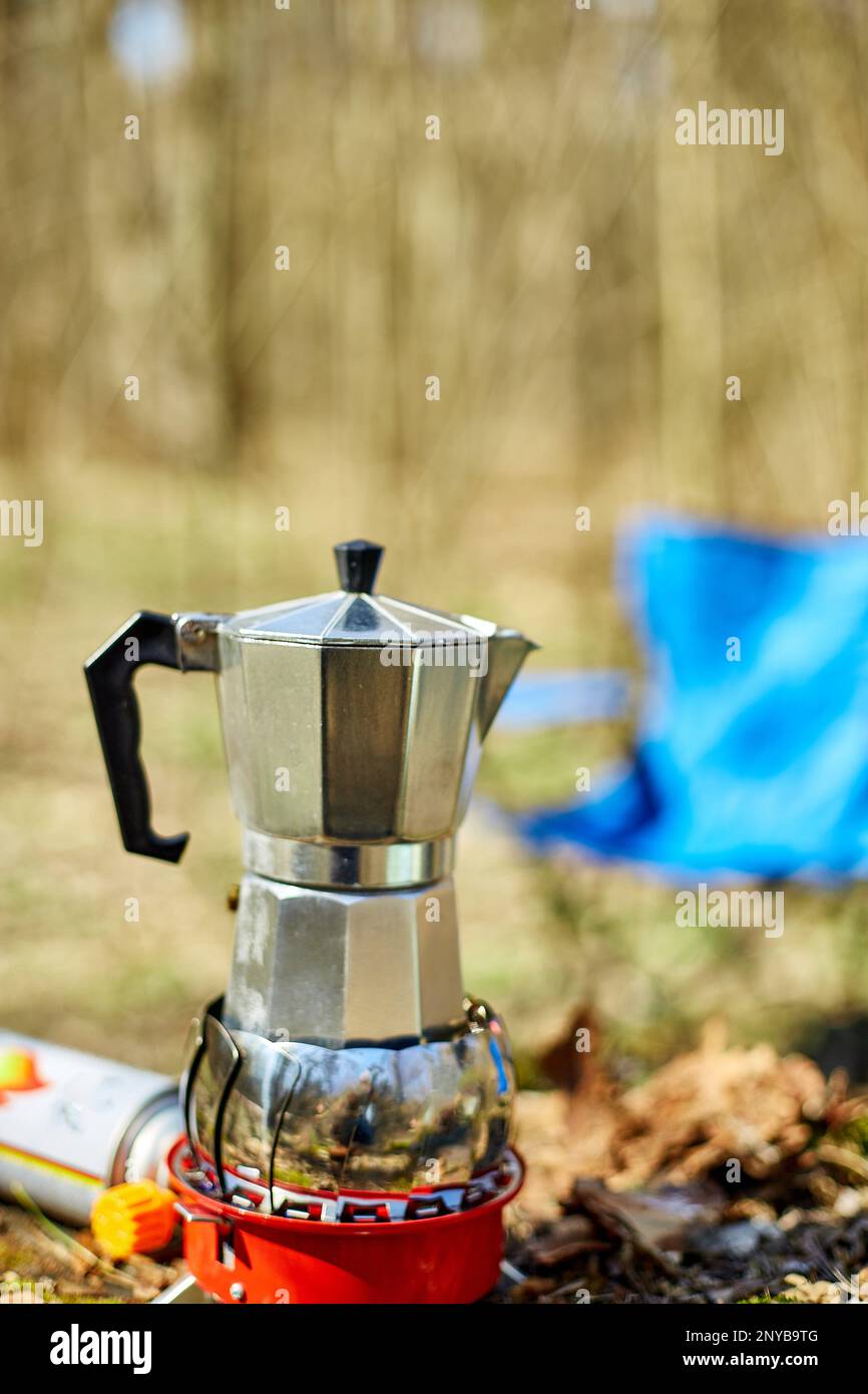https://c8.alamy.com/comp/2NYB9TG/making-camping-coffee-from-a-geyser-coffee-maker-on-a-gas-burner-autumn-outdoor-male-prepares-coffee-outdoors-travel-activity-for-relaxing-2NYB9TG.jpg