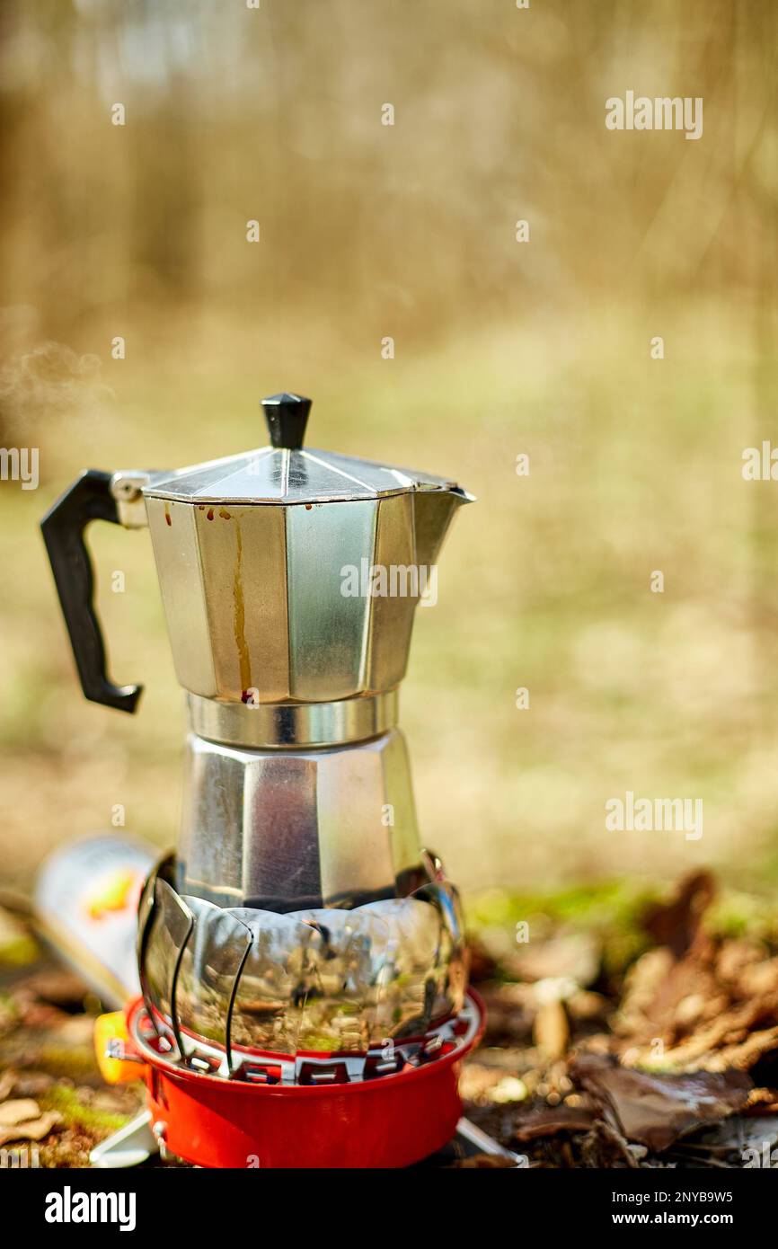 Process of making camping coffee outdoor with metal geyser coffee