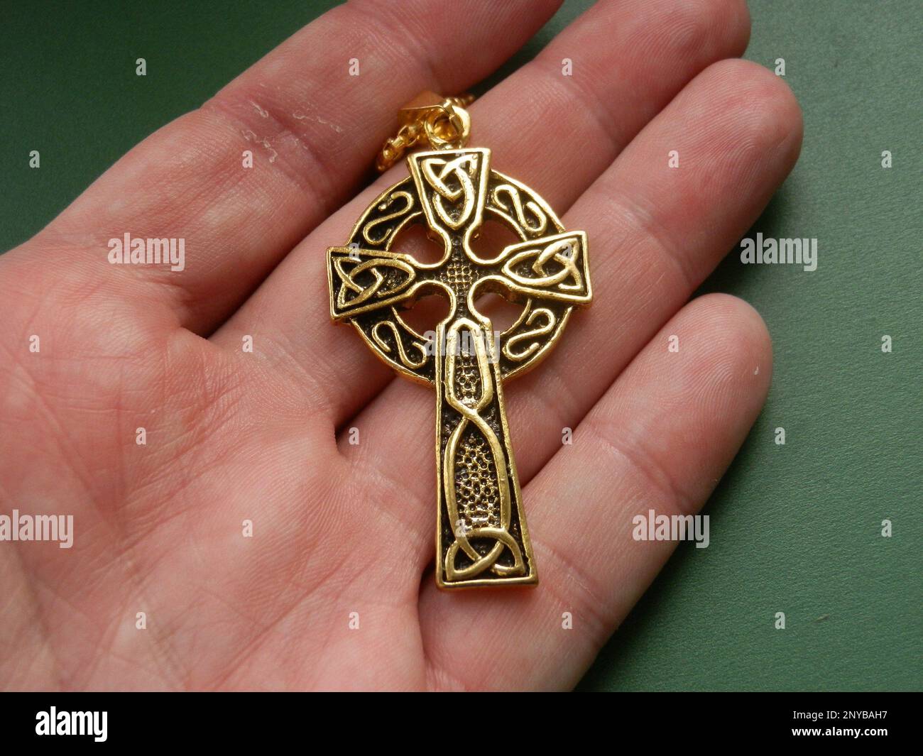 Religious metal symbol medallion in the hand Stock Photo Alamy