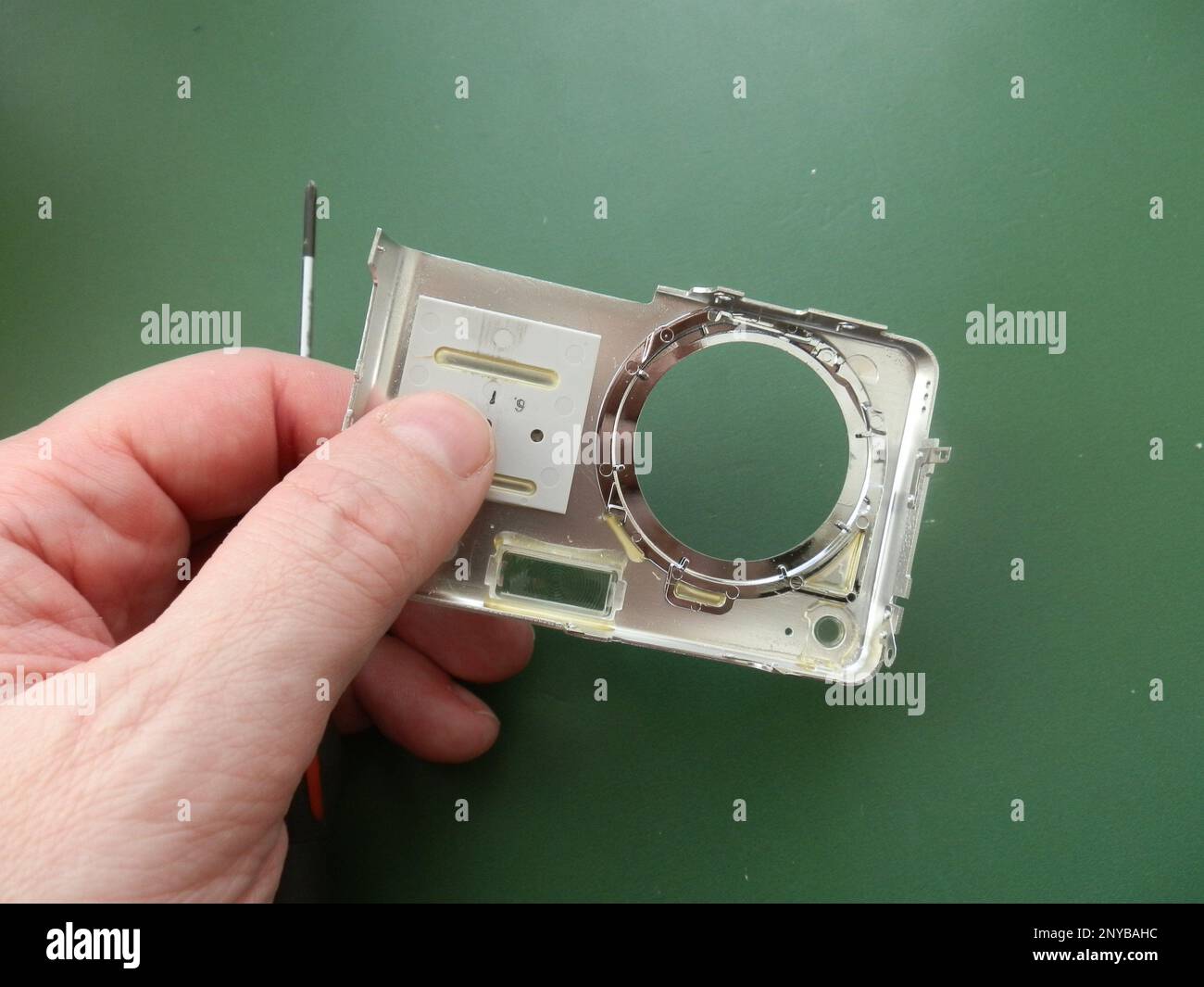Repair and disassembly of a the pocket digital camera. Stock Photo