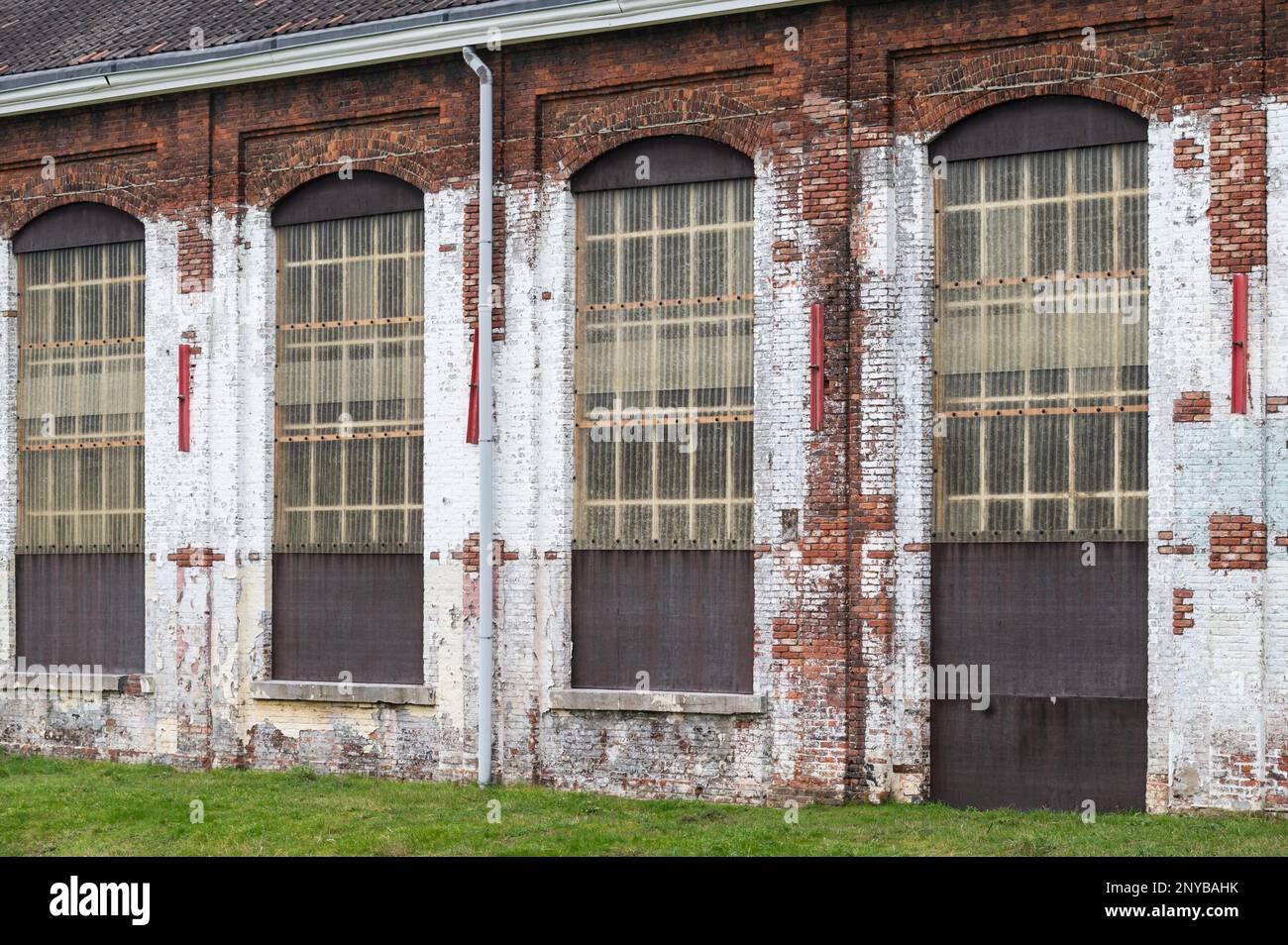 Kessel-Lo, Flemish Brabant, Belgium - Feb 11 2023 - Worn brick stone facade of the Hal 5, a former industrial site for the maintenance of trains. Stock Photo
