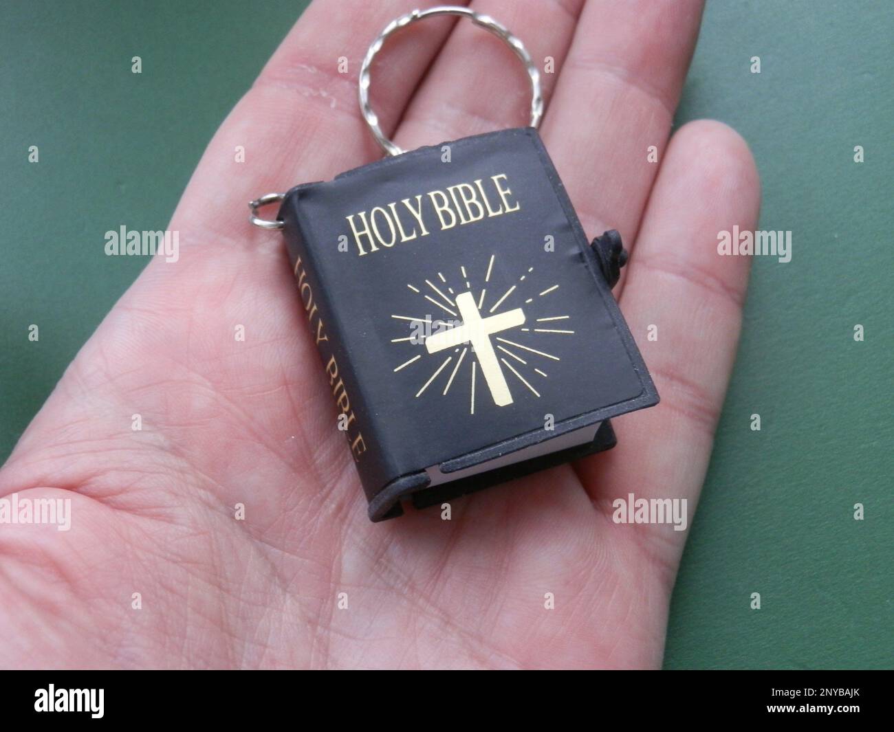 Religious metal symbol medallion in the hand. Stock Photo