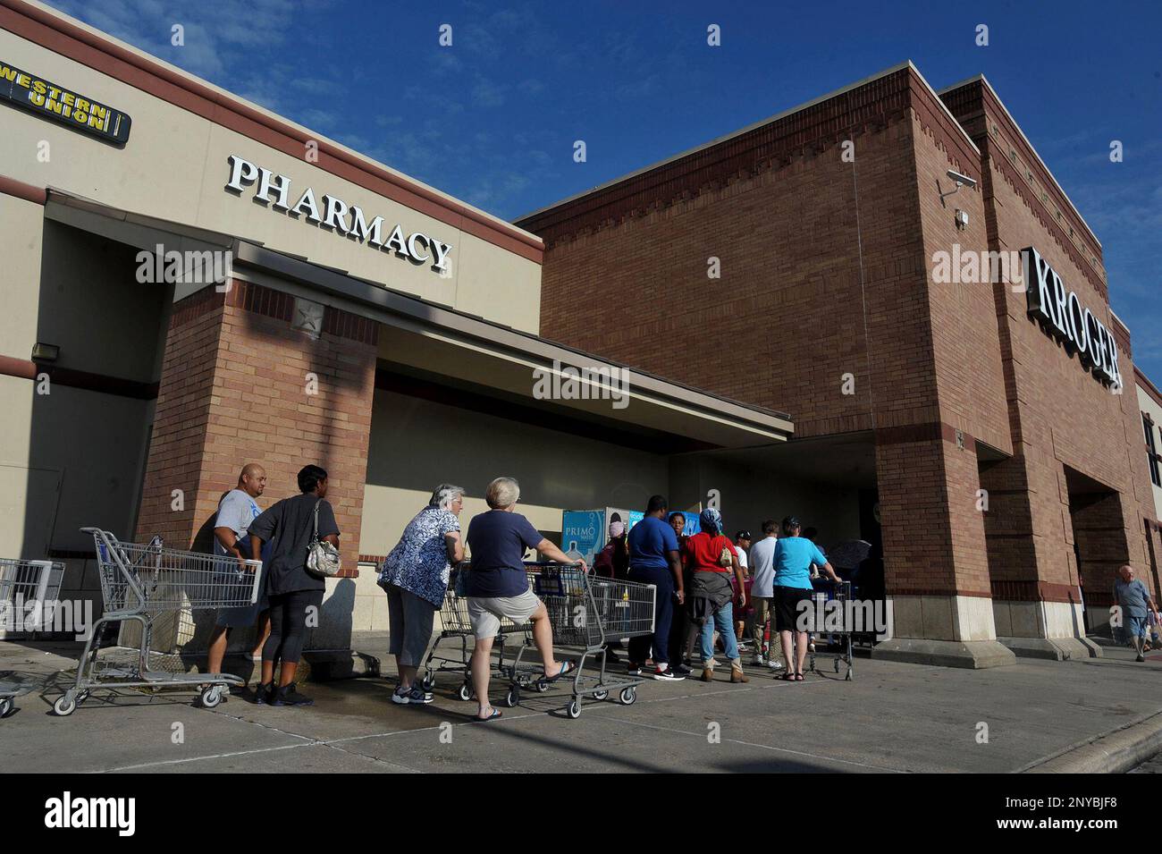 Shoppers line up to get into the Kroger on Dowlen Road in Beaumont